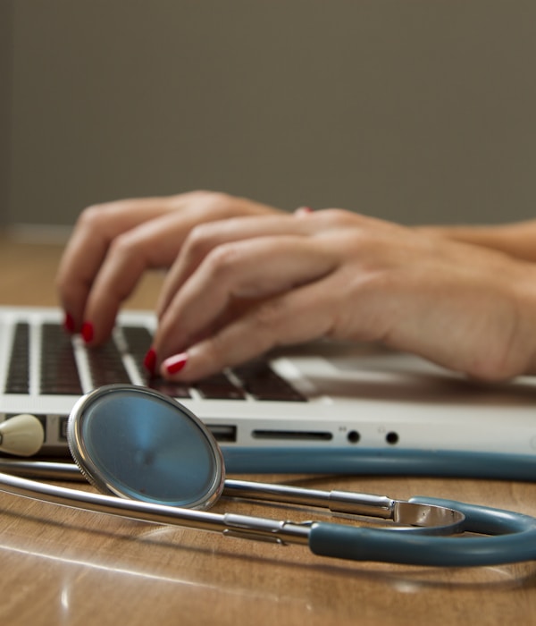 A smartphone displaying health information, resting near medical items on a desk